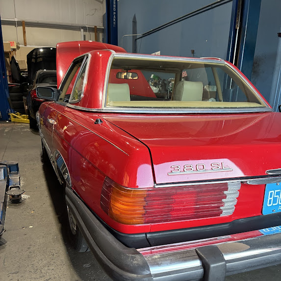 Red 1983 Mercedes-Benz 380SL in the shop