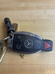 Mercedes-Benz key fob on a wooden surface